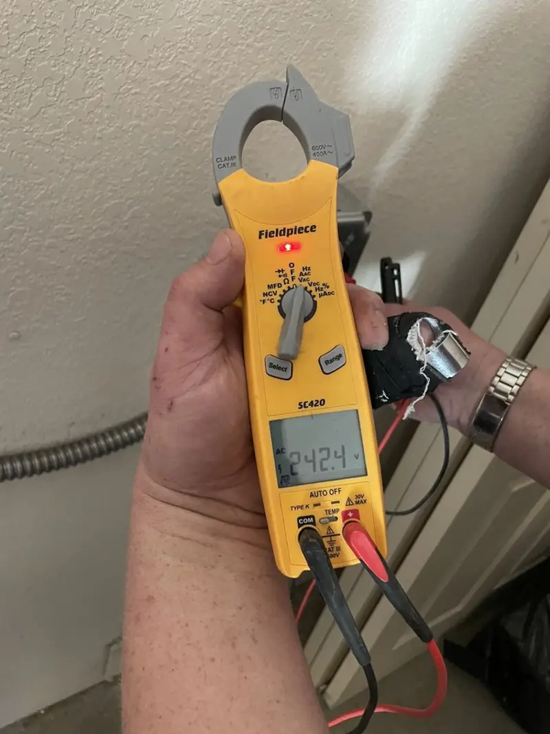 Voltage testing with clamp meter during Outlet Installation in Lake Holiday